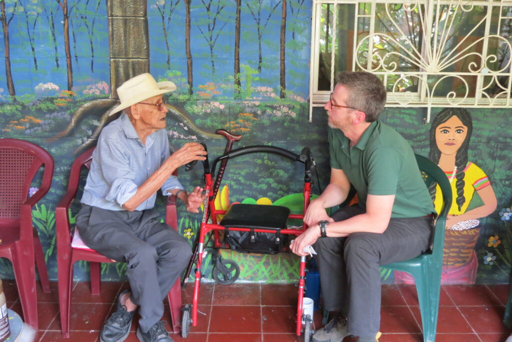 Elderly man talking with delegation leader